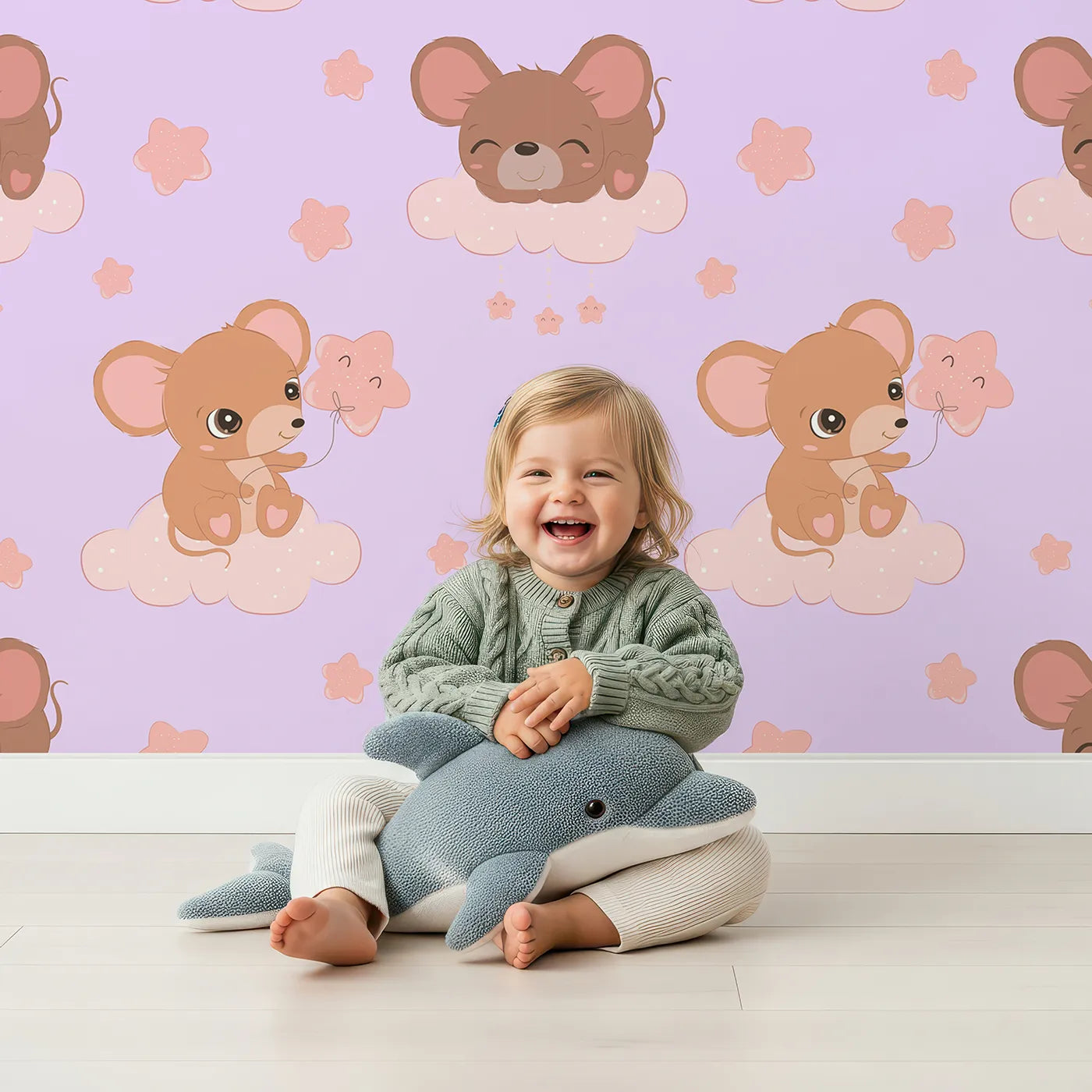 Lovely child standing in front of Whimsy Tots Starry Cloud Mouse Wallpaper in Purple with mouse, cloud, balloon, star in design.