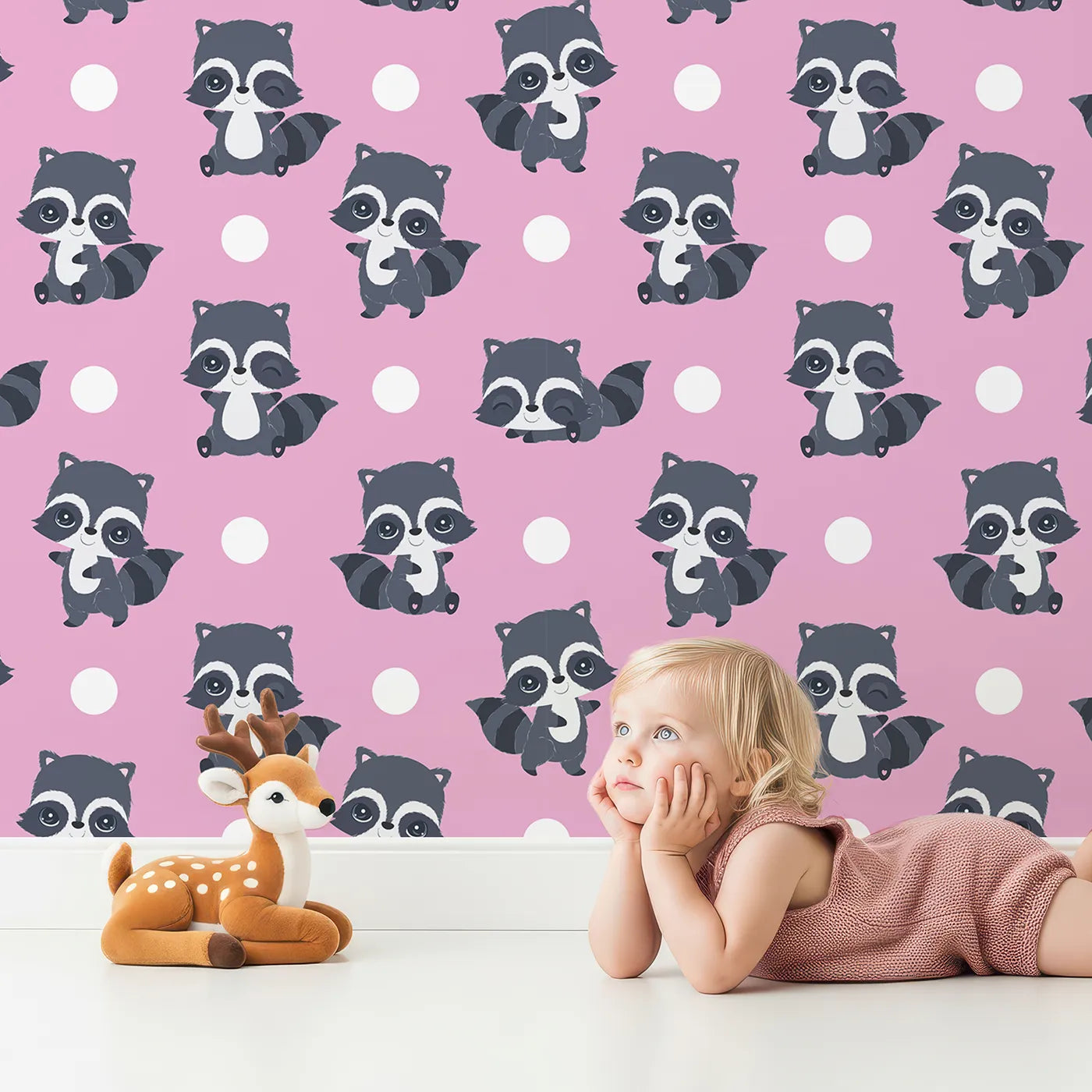 Lovely child standing in front of Whimsy Tots Playful Raccoon Parade Wallpaper in Pink with raccoon, dot in design.
