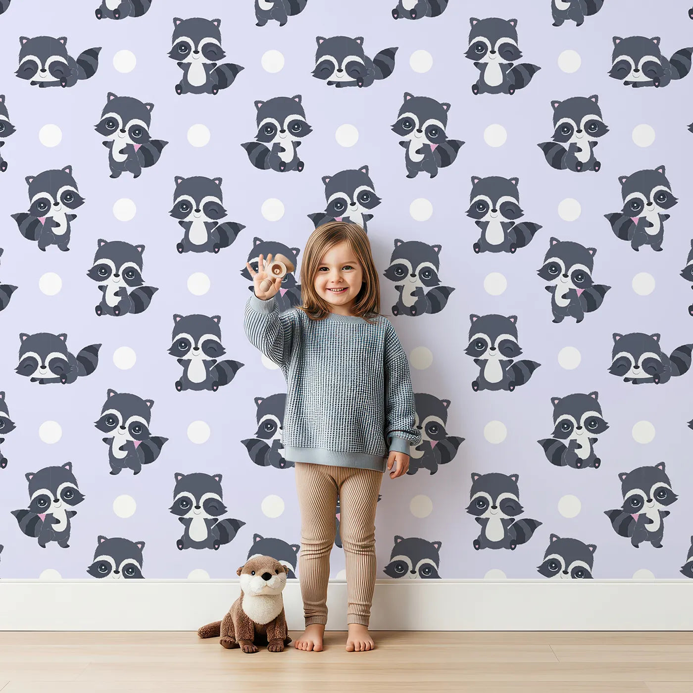 Lovely child standing in front of Whimsy Tots Playful Raccoon Parade Wallpaper in Purple with raccoon, dot in design.
