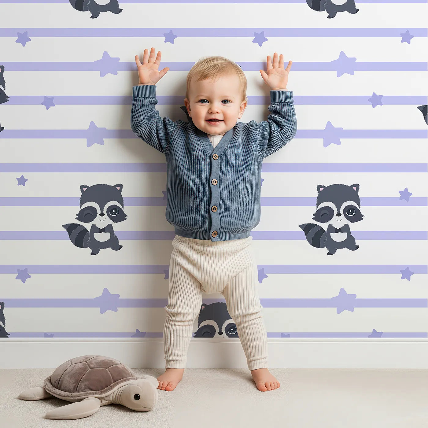 Lovely child standing in front of Whimsy Tots Starlit Raccoon Stripes Wallpaper in Lavender with raccoon, star, stripe in design.