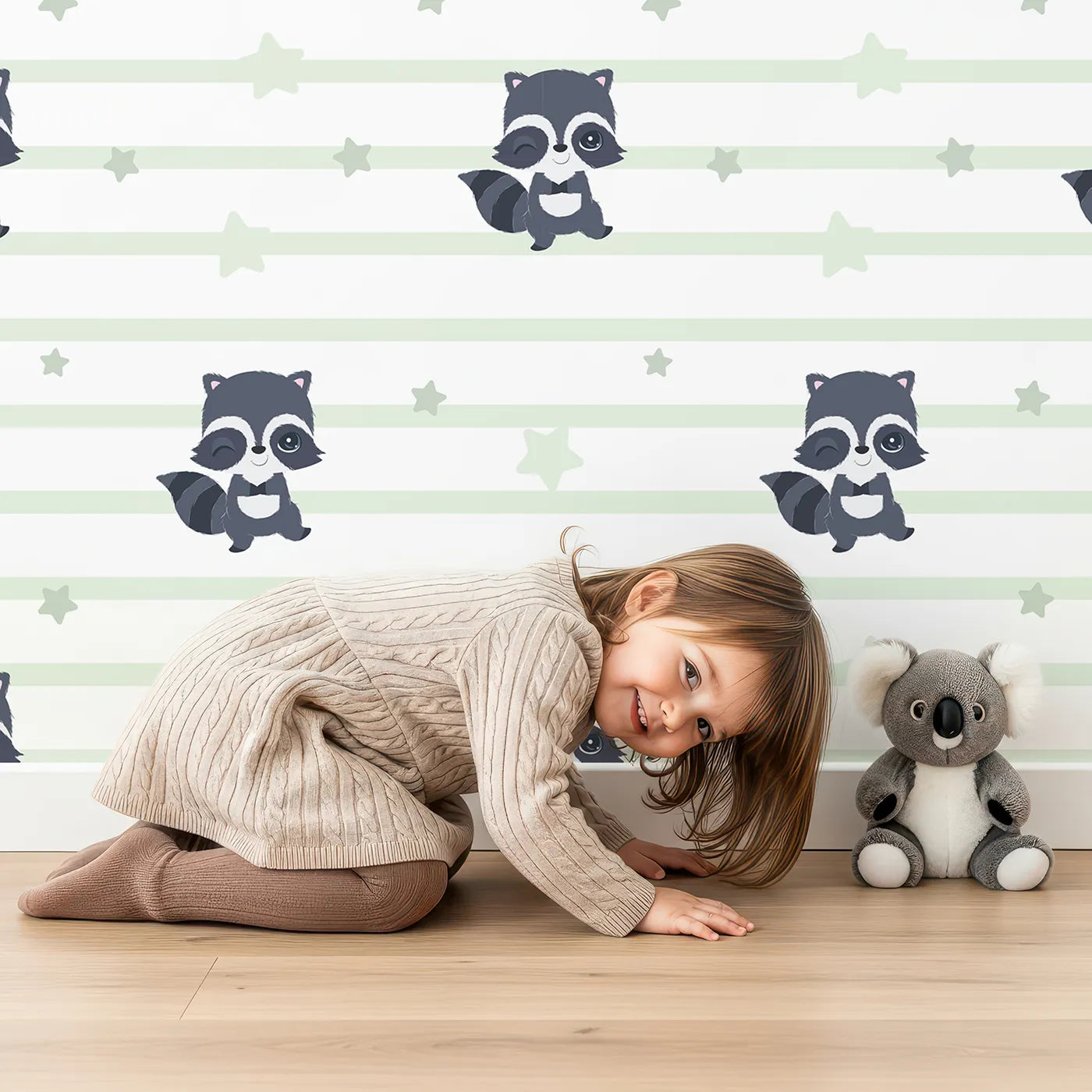 Lovely child standing in front of Whimsy Tots Starlit Raccoon Stripes Wallpaper in Green with raccoon, star, stripe in design.