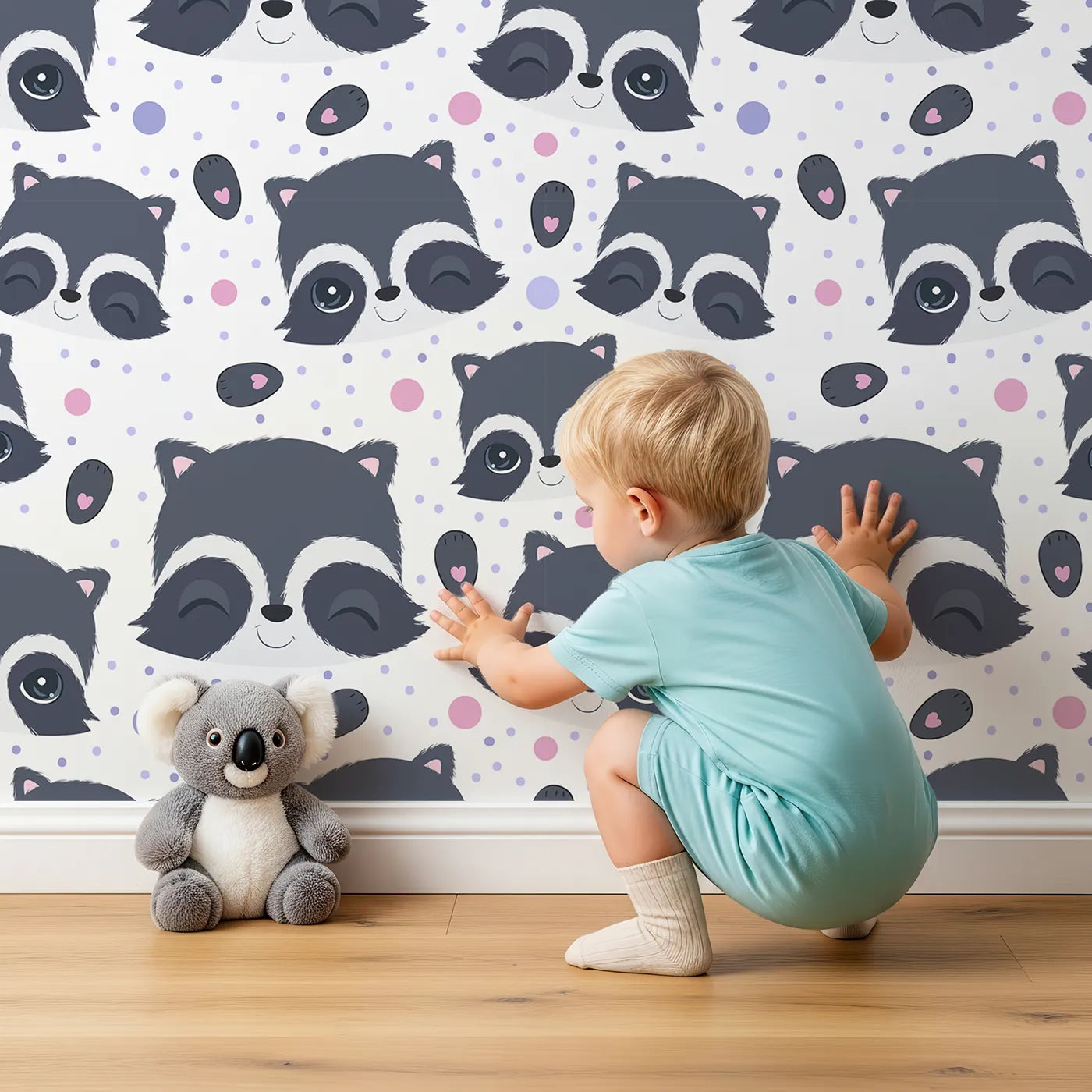Lovely child standing in front of Whimsy Tots Winkie Raccoon Pals Wallpaper with raccoon, dot, paw in design.