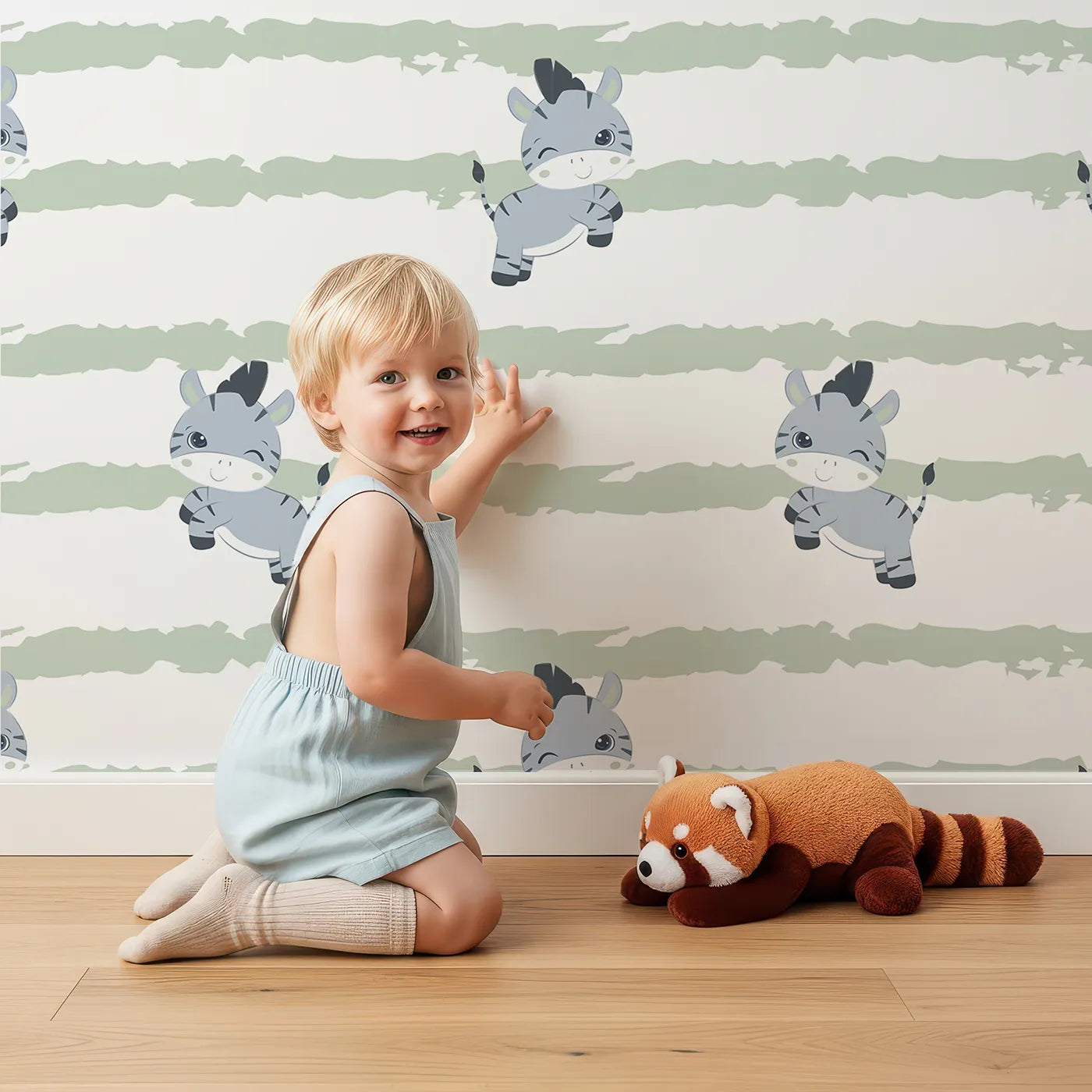 Lovely child standing in front of Whimsy Tots Winkie the Zebra Wallpaper in Sage Green with zebra, stripe in design.