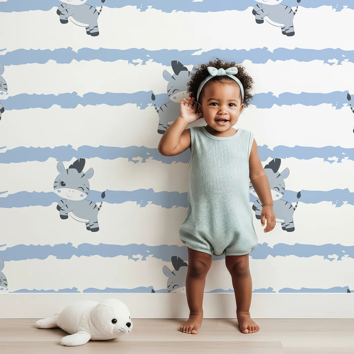 Lovely child standing in front of Whimsy Tots Winkie the Zebra Wallpaper in Blue with zebra, stripe in design.