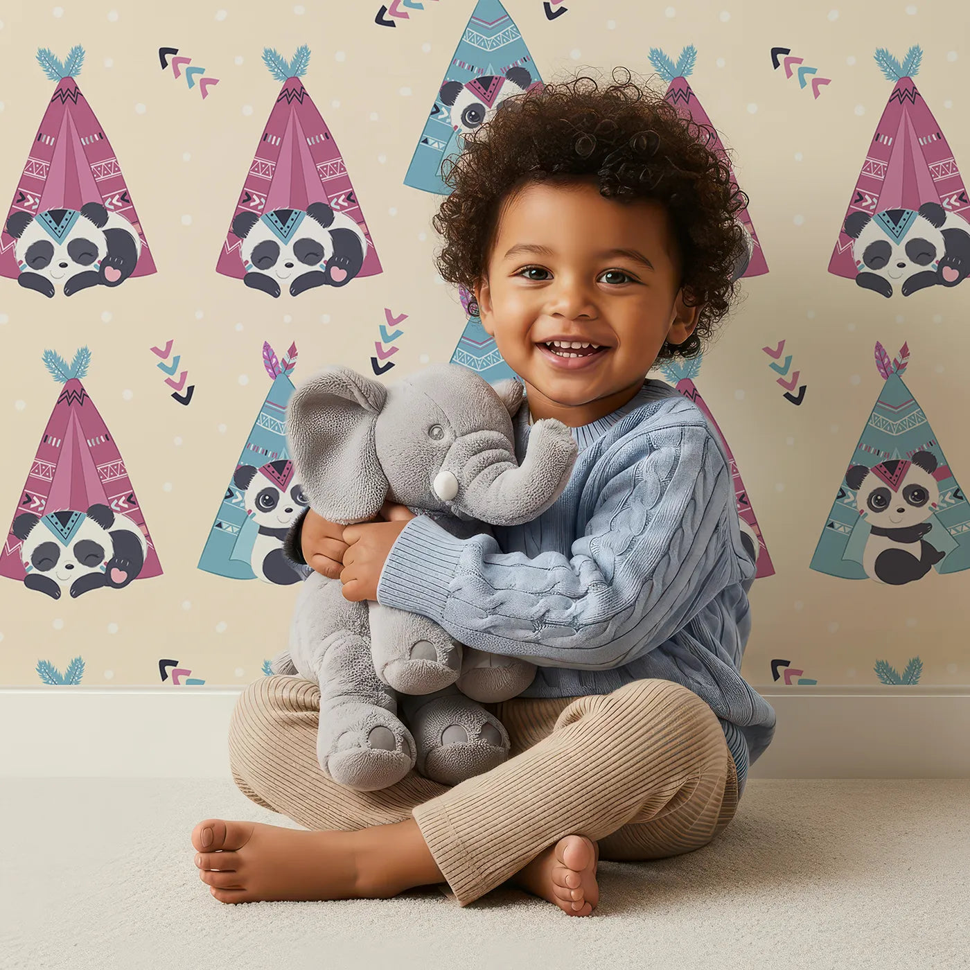 Lovely child standing in front of Whimsy Tots Tribal Camp Panda Wallpaper in Beige with panda, teepee, feather, arrow, dot in design.