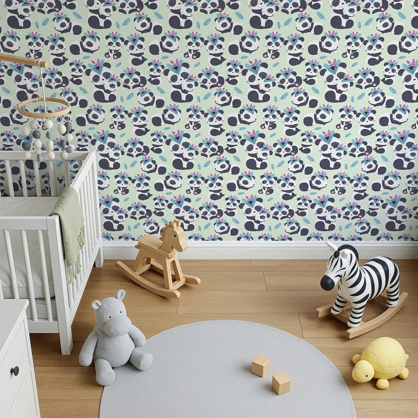 Top-Down view of Whimsy Tots' Tribal Hug Panda Wallpaper in Mint Green (W3040D).Smiling pandas in tribal feathers play on a gentle minty green field.