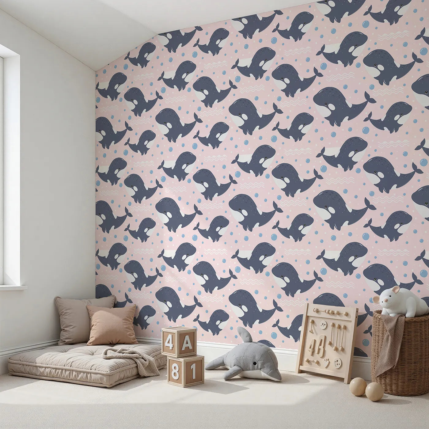 Angled view of Whimsy Tots' Orca Whale Wonder Wallpaper in Blush Pink (W3045B).Smiley orcas splash across a soft sea of blush bubbles.