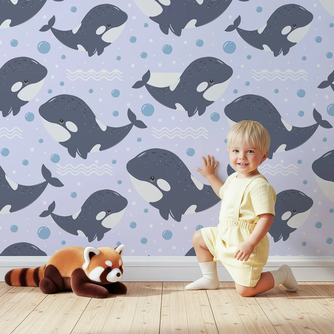 Lovely child standing in front of Whimsy Tots Orca Whale Wonder Wallpaper in Lilac Lavender with whale, orca, bubble, wave in design.