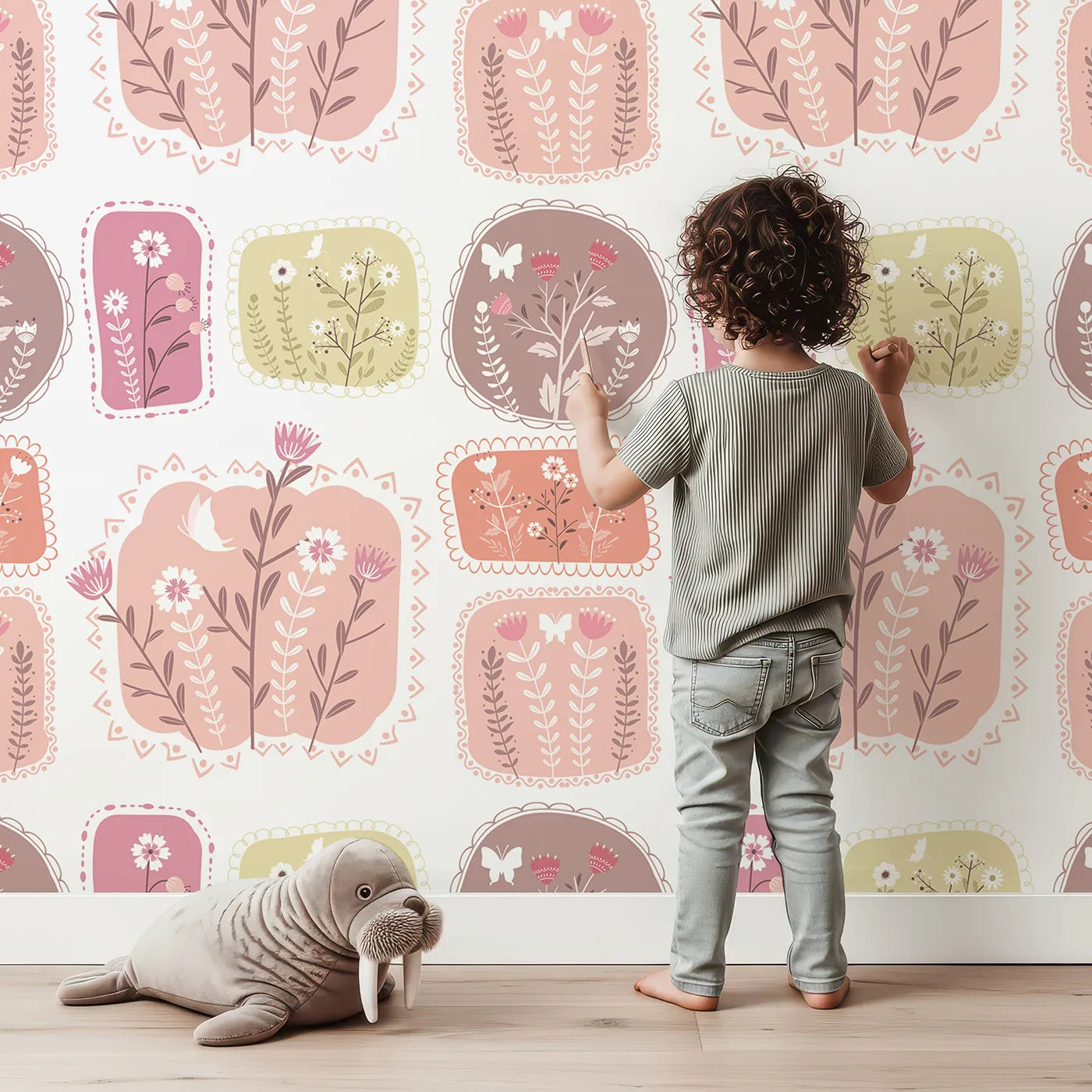 Lovely child standing in front of Whimsy Tots Botanical Patchwork Garden Wallpaper with flower, butterfly, bird, patch in design.