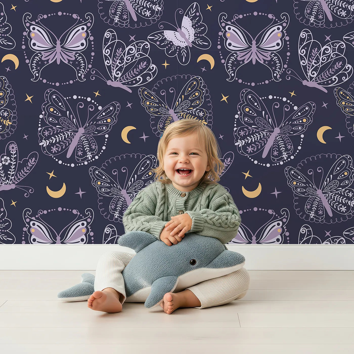 Lovely child standing in front of Whimsy Tots Starglow Garden Butterfly Wallpaper in Midnight Navy Blue with butterfly in design.