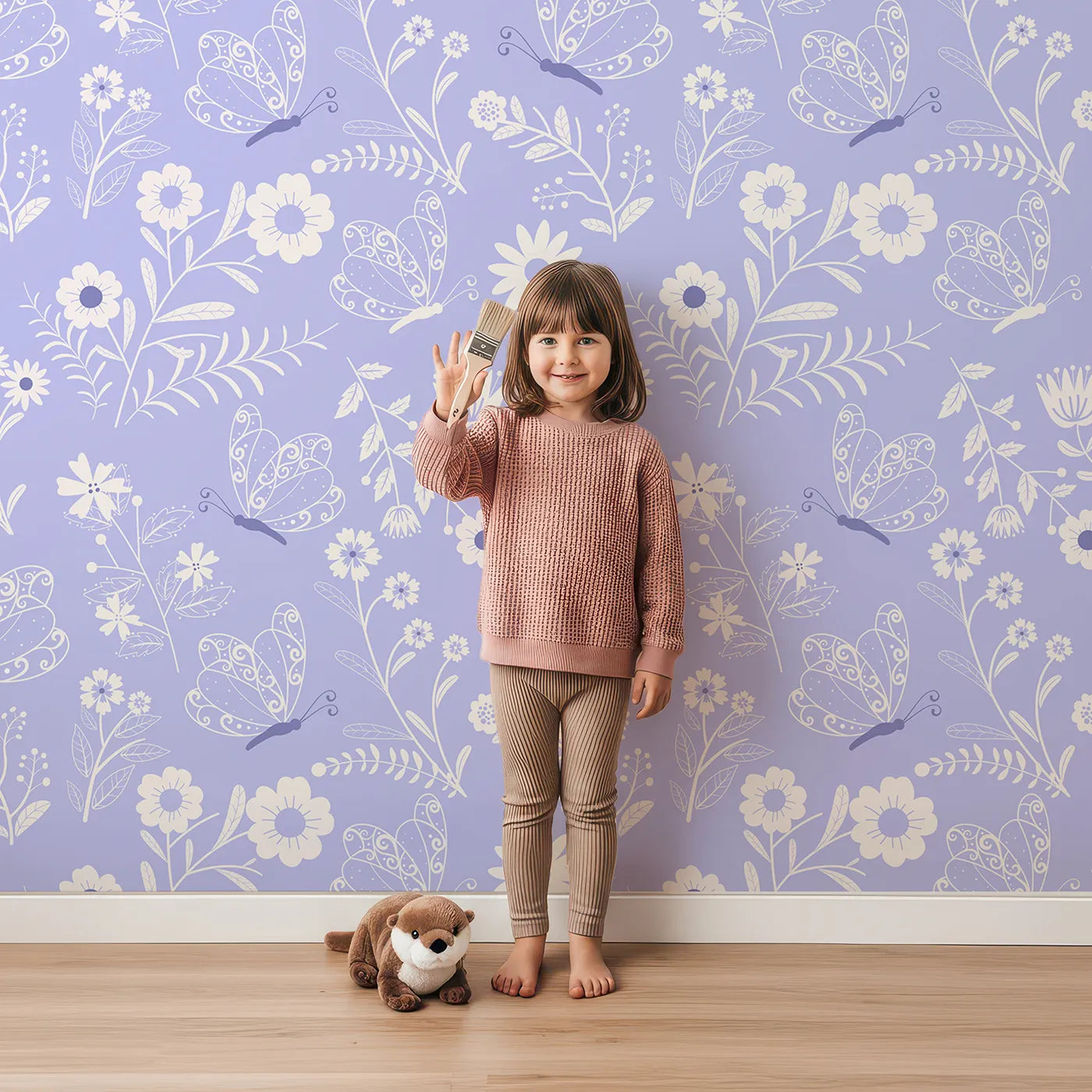 Lovely child standing in front of Whimsy Tots Floral Flutter Butterfly Wallpaper in Lavender Mist with butterfly, flower, leaf in design.