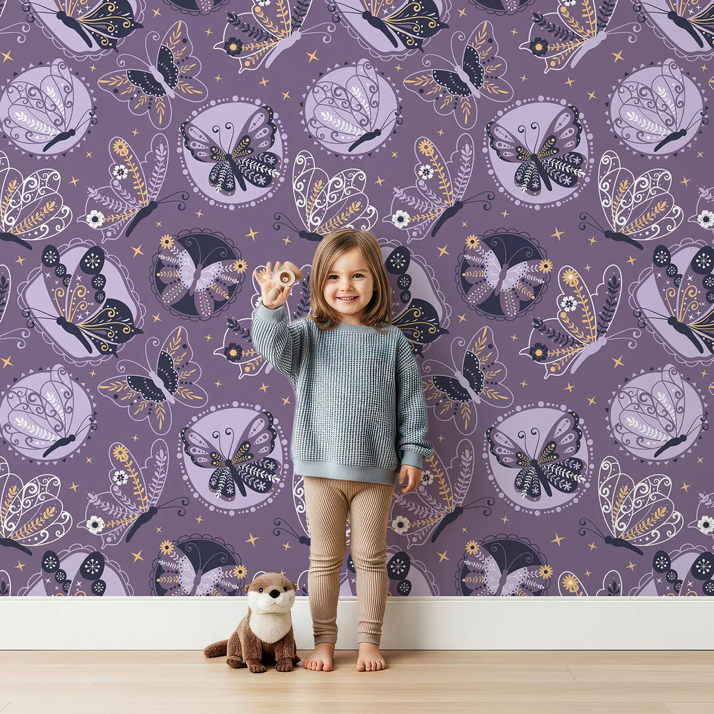 Lovely child standing in front of Whimsy Tots Twilight Tapestry Butterfly Wallpaper in Grape Purple with butterfly, flower, leaf, circle, dot in design.