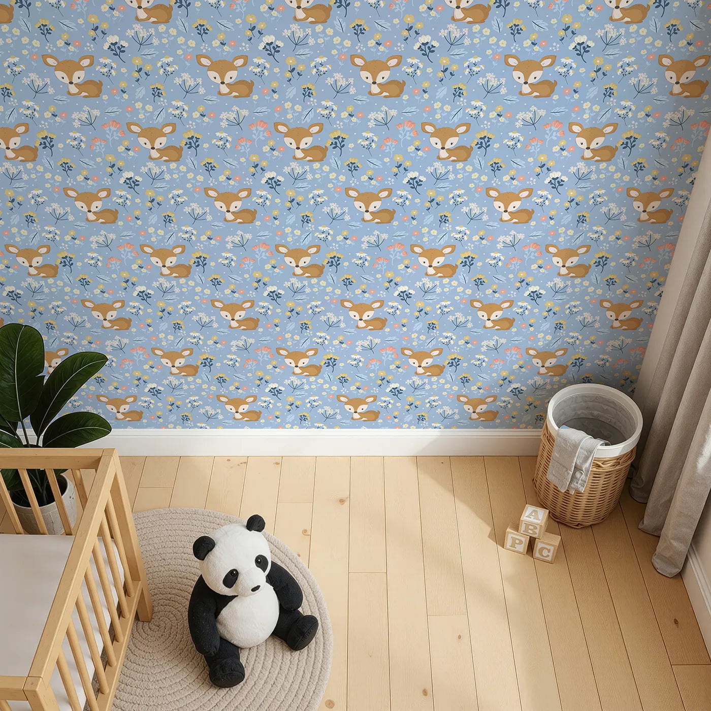 Top-Down view of Whimsy Tots' Meadow Cuddles Deer Wallpaper in Cornflower Blue (W3059E).Quiet baby deer rest beneath blossoms on a cool cornflower blue background.