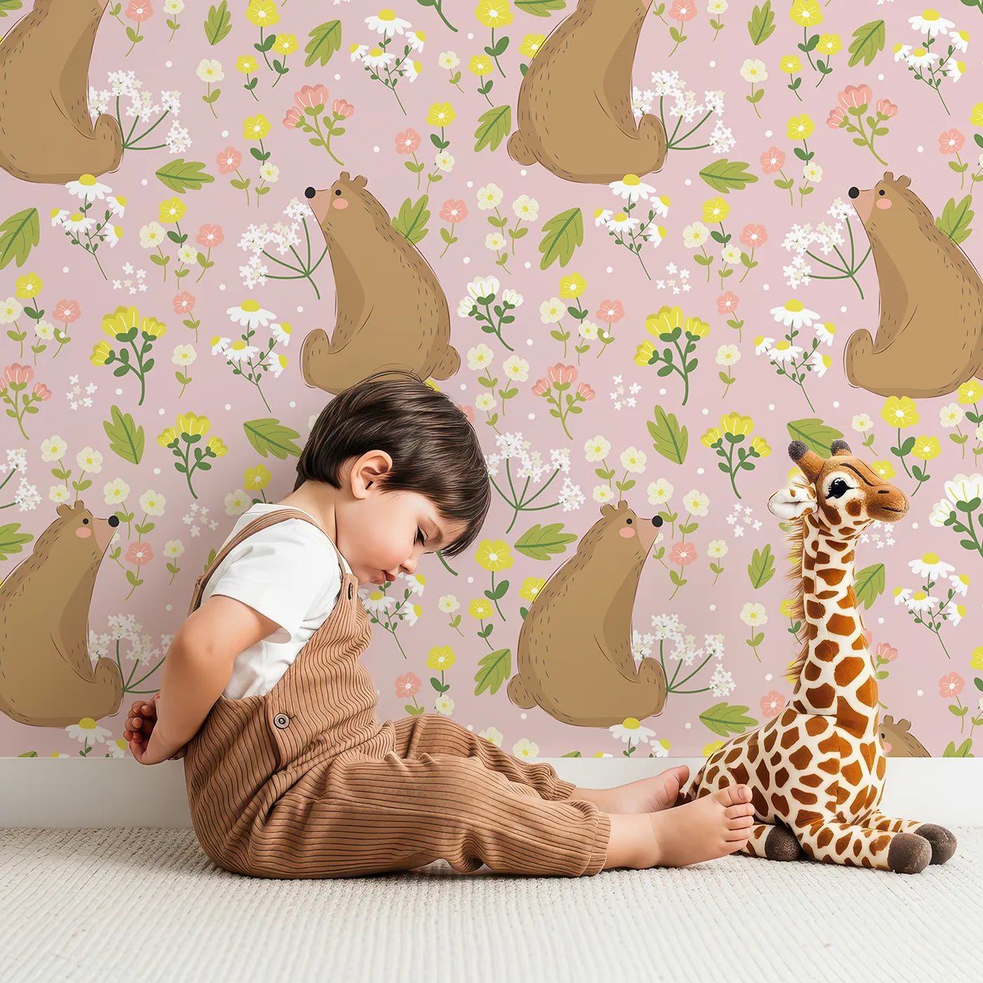 Lovely child standing in front of Whimsy Tots Blossom Bear Meadow Wallpaper in Blush Rose Pink with bear, flower, leaf, blossom in design.