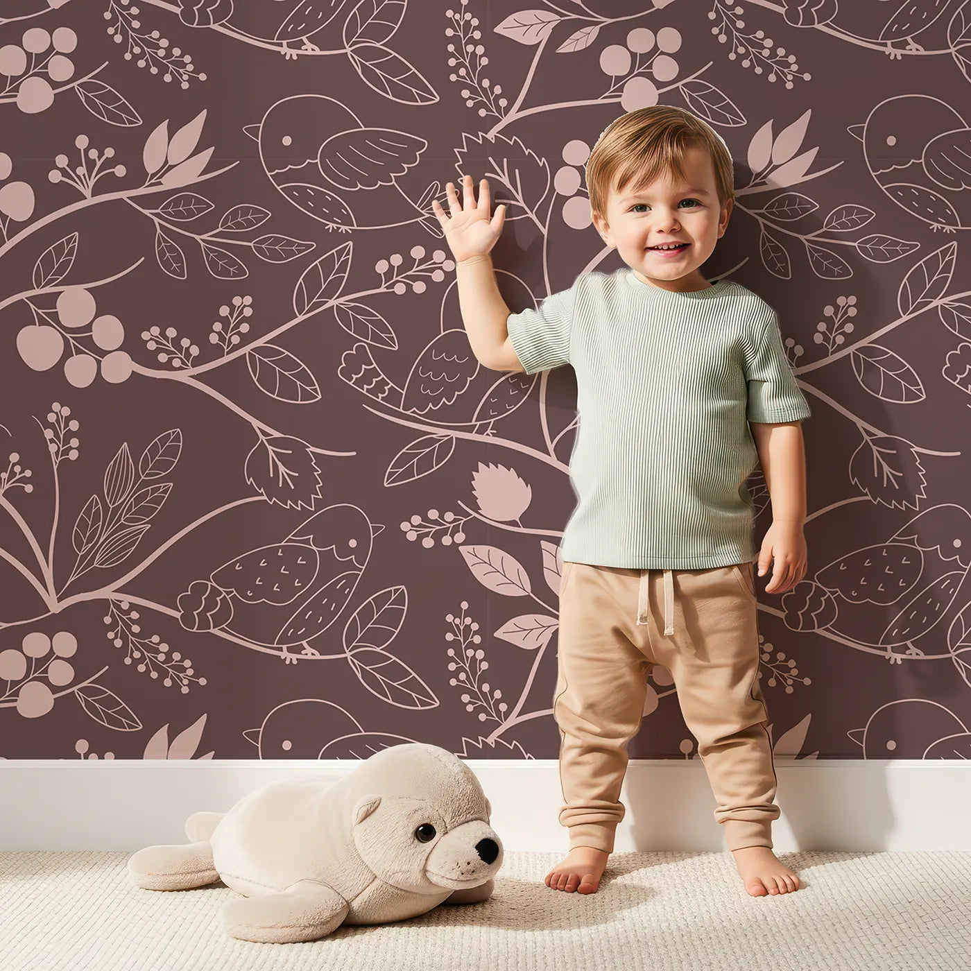 Lovely child standing in front of Whimsy Tots Woodland Silhouette Birds Wallpaper in Cocoa Brown with bird, leaf, branch, berry in design.