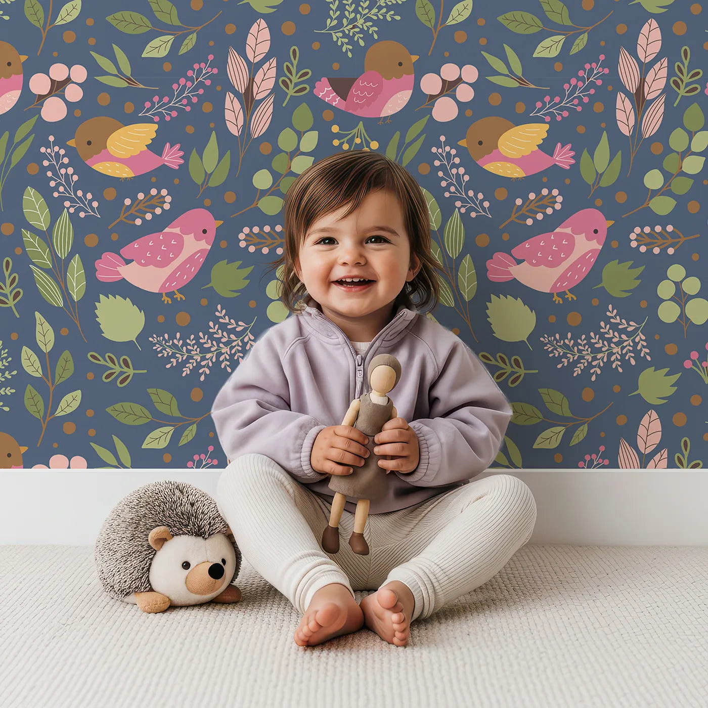 Lovely child standing in front of Whimsy Tots Bramble Songbird Garden Wallpaper in Navy Blue with bird, leaf, berry, flower, twig in design.