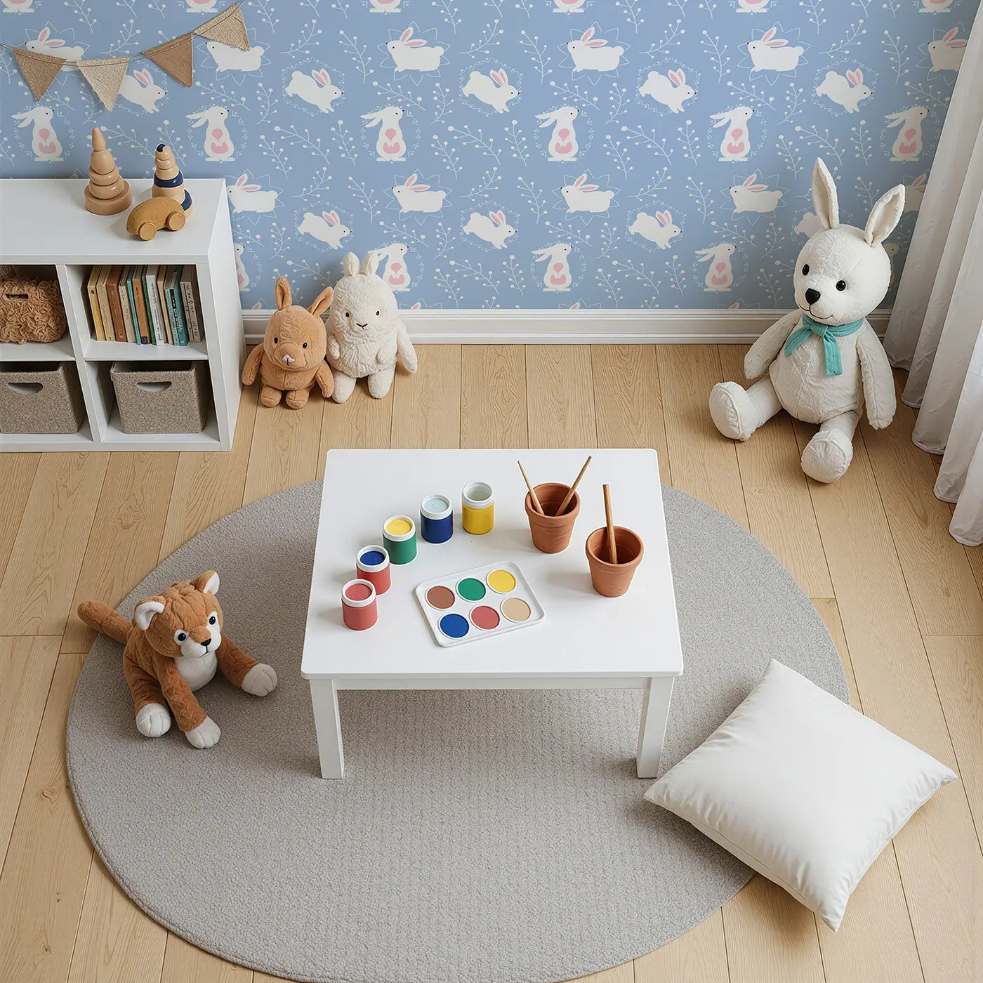 Top-Down view of Whimsy Tots' Tribal Bunny Sprigs Wallpaper in Sky Blue (W3075D).White rabbits hop across blue skies framed by tribal shapes and forest sprigs.