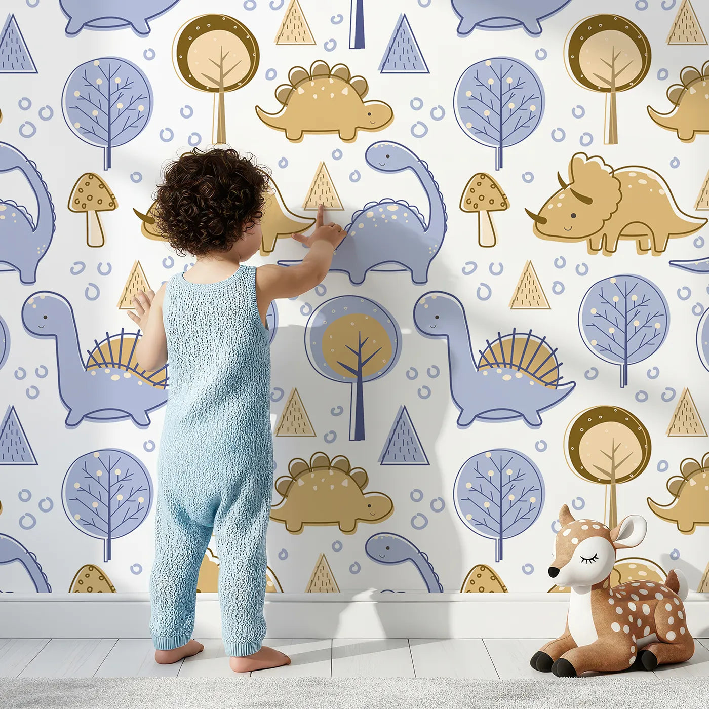 Lovely child standing in front of Whimsy Tots Jurassic Forest Friends Wallpaper in White with dinosaur, tree, triangle, dino, forest in design.
