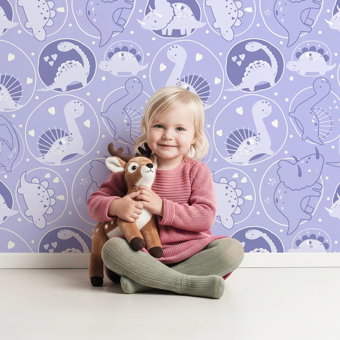 Lovely child standing in front of Whimsy Tots Dino Circle Parade Wallpaper in Lavender with dinosaur, flower, heart, circle in design.