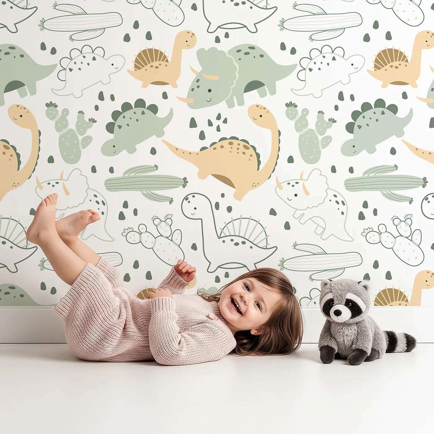 Lovely child standing in front of Whimsy Tots Cactus Canyon Dinos Wallpaper in Mint Green with dinosaur, cactus, rock, spike in design.