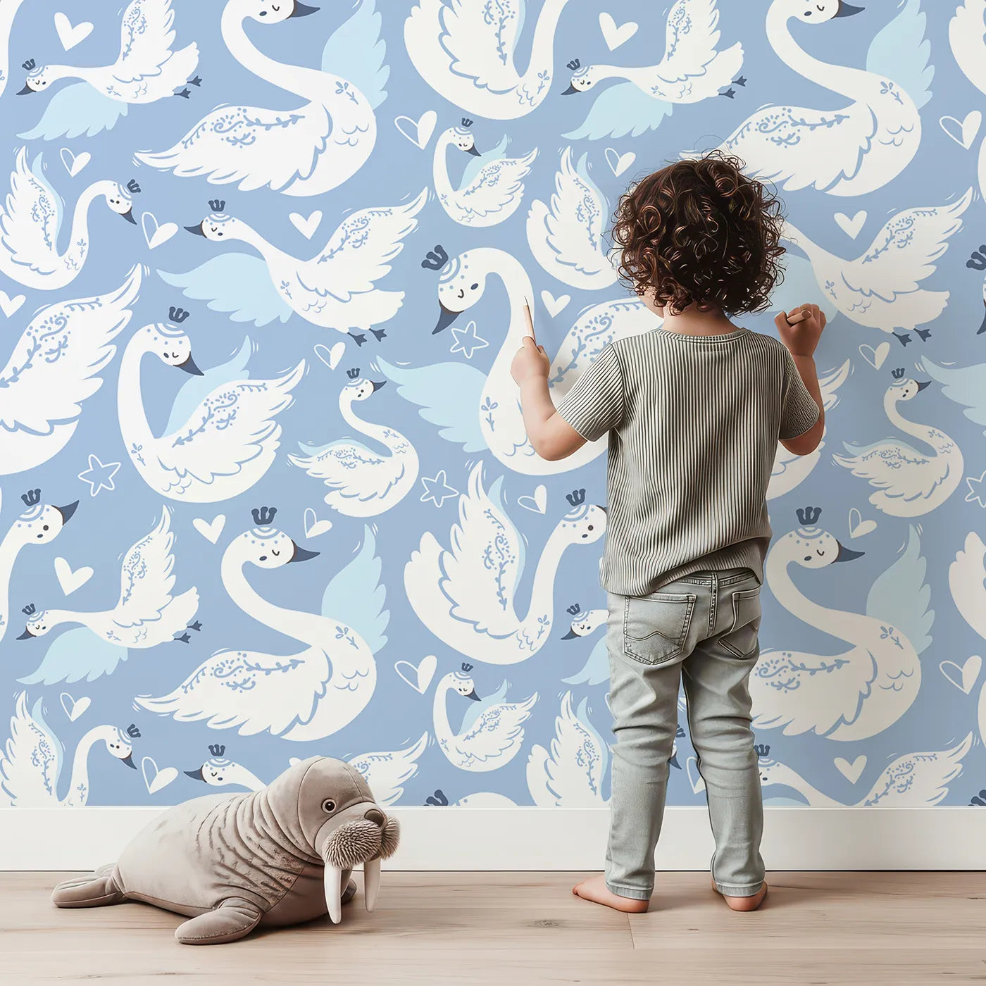 Lovely child standing in front of Whimsy Tots Swan Princess Waltz Wallpaper in Blue with swan, crown, wing, heart, star in design.