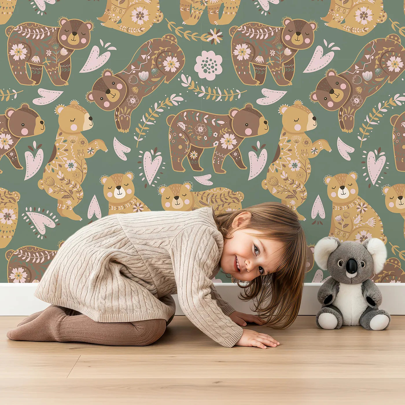 Lovely child standing in front of Whimsy Tots Floral Snuggle Bears Wallpaper in Forest Green with bear, flower, heart, leaf in design.