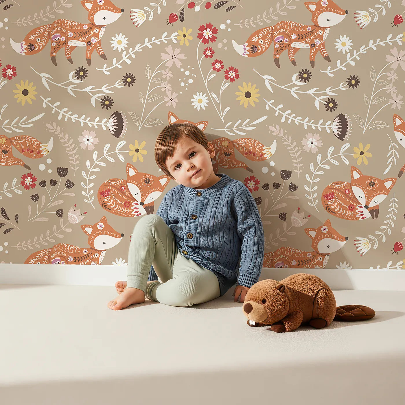 Lovely child standing in front of Whimsy Tots Folk Bloom Foxes Wallpaper in Sandstone Beige with fox, flower, vine in design.