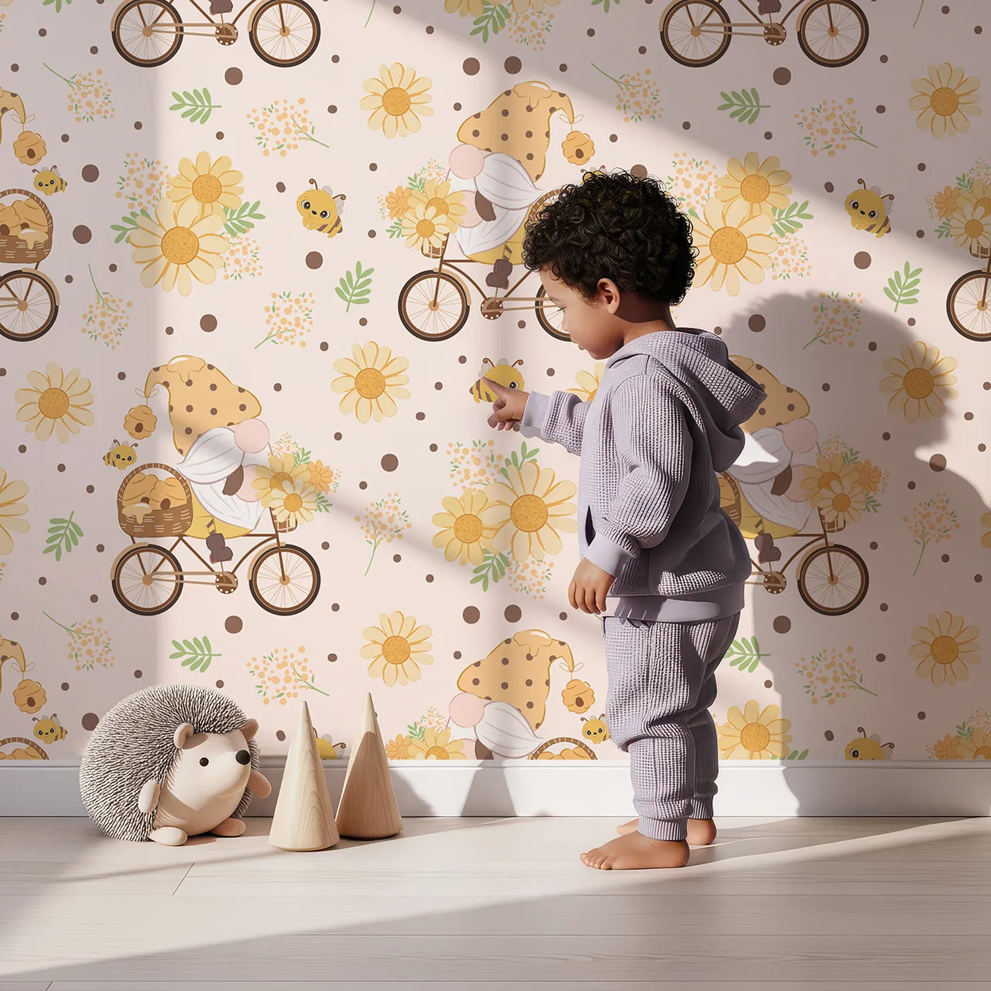 Lovely child standing in front of Whimsy Tots Honeybee Gnome Parade Wallpaper in Buttercream with gnome, bee, flower, bicycle in design.