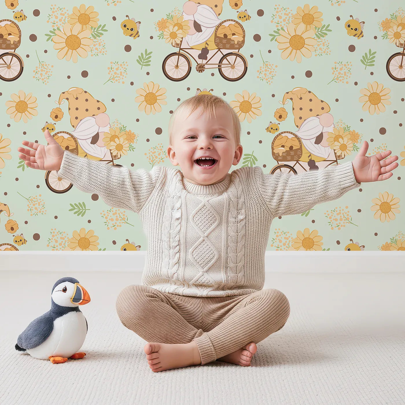 Lovely child standing in front of Whimsy Tots Honeybee Gnome Parade Wallpaper in Mint Meadow Green with gnome, bee, flower, bicycle in design.