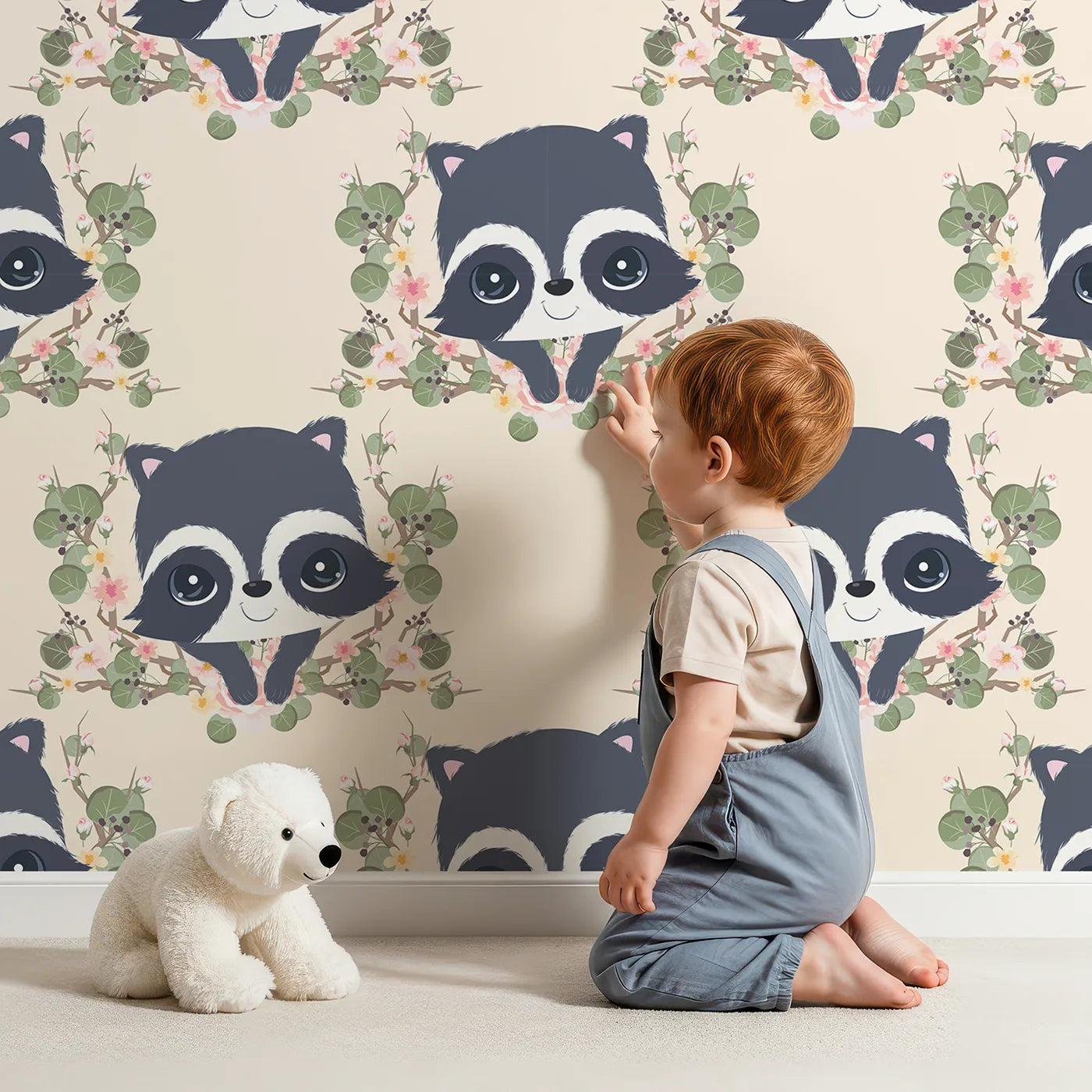Lovely child standing in front of Whimsy Tots Floral Raccoon Peek Wallpaper in Soft Cream with raccoon, flower, crown, leaf, branch in design.