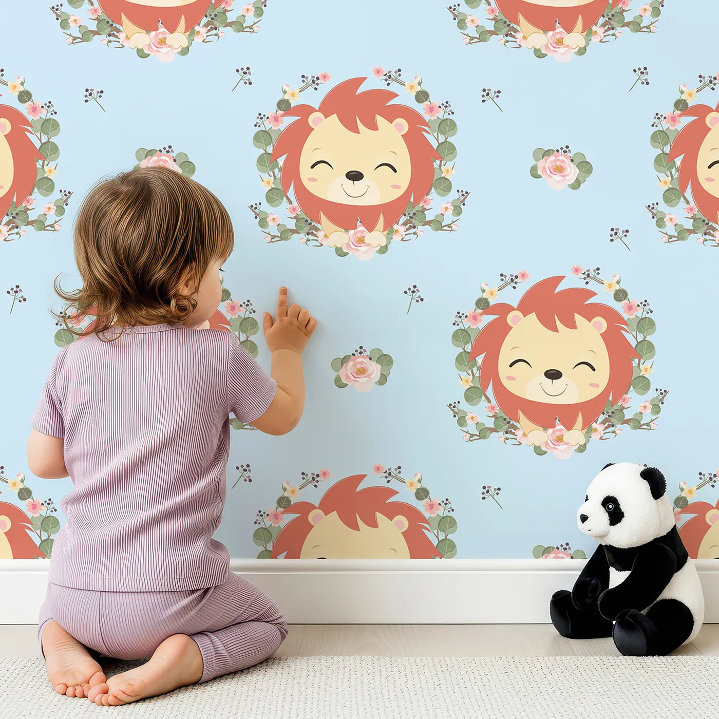 Lovely child standing in front of Whimsy Tots Little Lion Blossom Parade Wallpaper in Sky Blue with lion, flower, wreath, leaf, blossom in design.