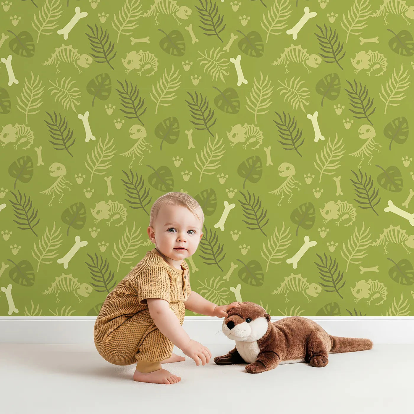 Lovely child standing in front of Whimsy Tots Fossil Roar Parade Wallpaper in Sage Green with dinosaur, skeleton, bone, footprint in design.