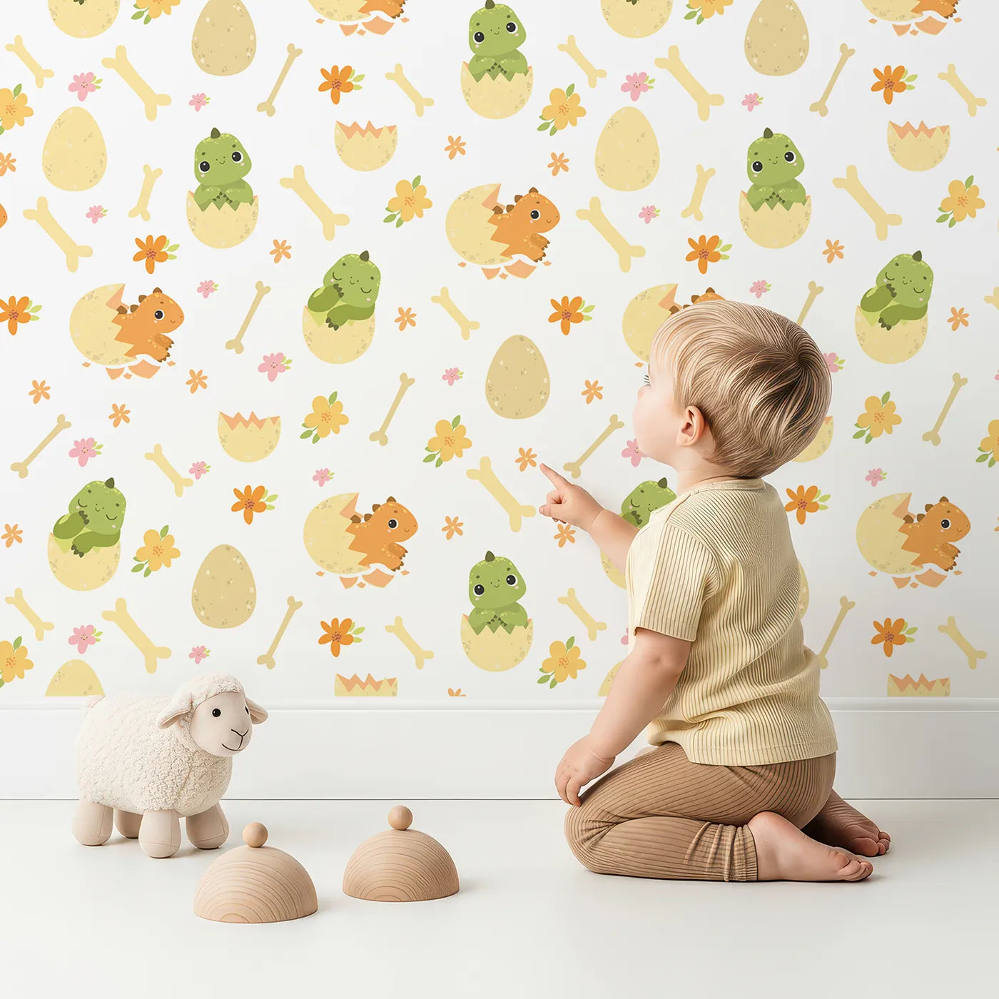 Lovely child standing in front of Whimsy Tots Hatchling Dino Parade Wallpaper in Soft Eggshell with dinosaur, egg, bone, flower in design.