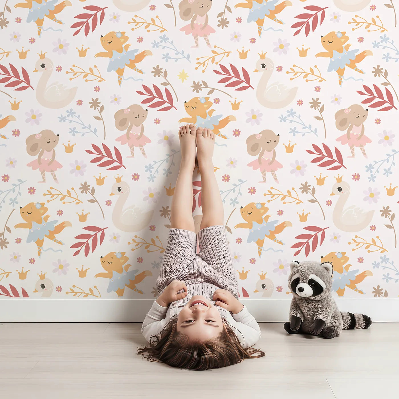 Lovely child standing in front of Whimsy Tots Woodland Ballet Parade Wallpaper in Petal Cream with fox, mouse, swan, flower, crown, leaf in design.