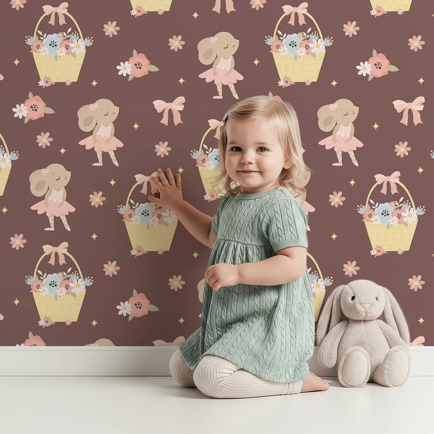 Lovely child standing in front of Whimsy Tots Ballet Mouse Garden Wallpaper in Cocoa Blossom Brown with mouse, flower, bow, basket in design.