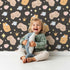 Lovely child standing in front of Whimsy Tots Royal Woodland Friends Wallpaper in Midnight Crown with fox, rabbit, bear, flower, crown, star in design. Lovely child standing in front of Whimsy Tots Royal Woodland Friends Wallpaper in Midnight Crown with fox, rabbit, bear, flower, crown, star in design.