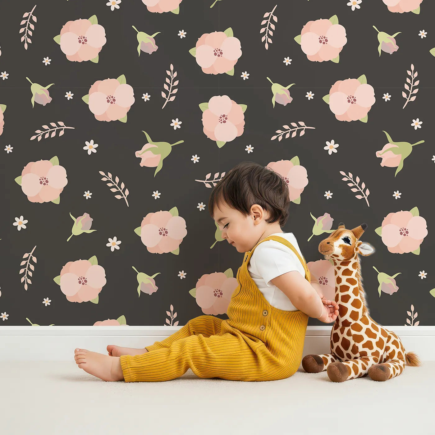 Lovely child standing in front of Whimsy Tots Blush Meadow Bloom Wallpaper in Midnight Cocoa Brown with flower, daisy, leaf, petal in design.