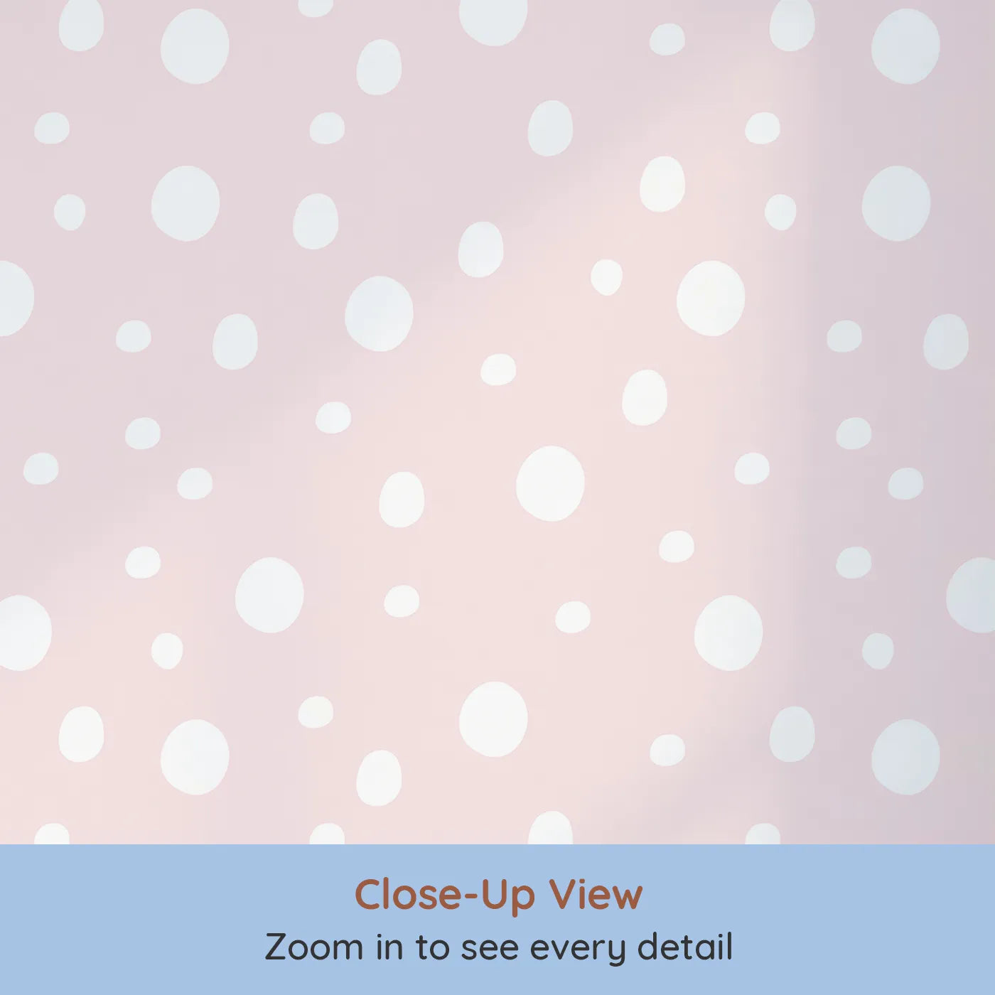 Close-up view of Whimsy Tots' Gentle Pebble Dots Wallpaper in Blush Cream (W3136A).White pebbled dots dance across a warm blush-pink sky.