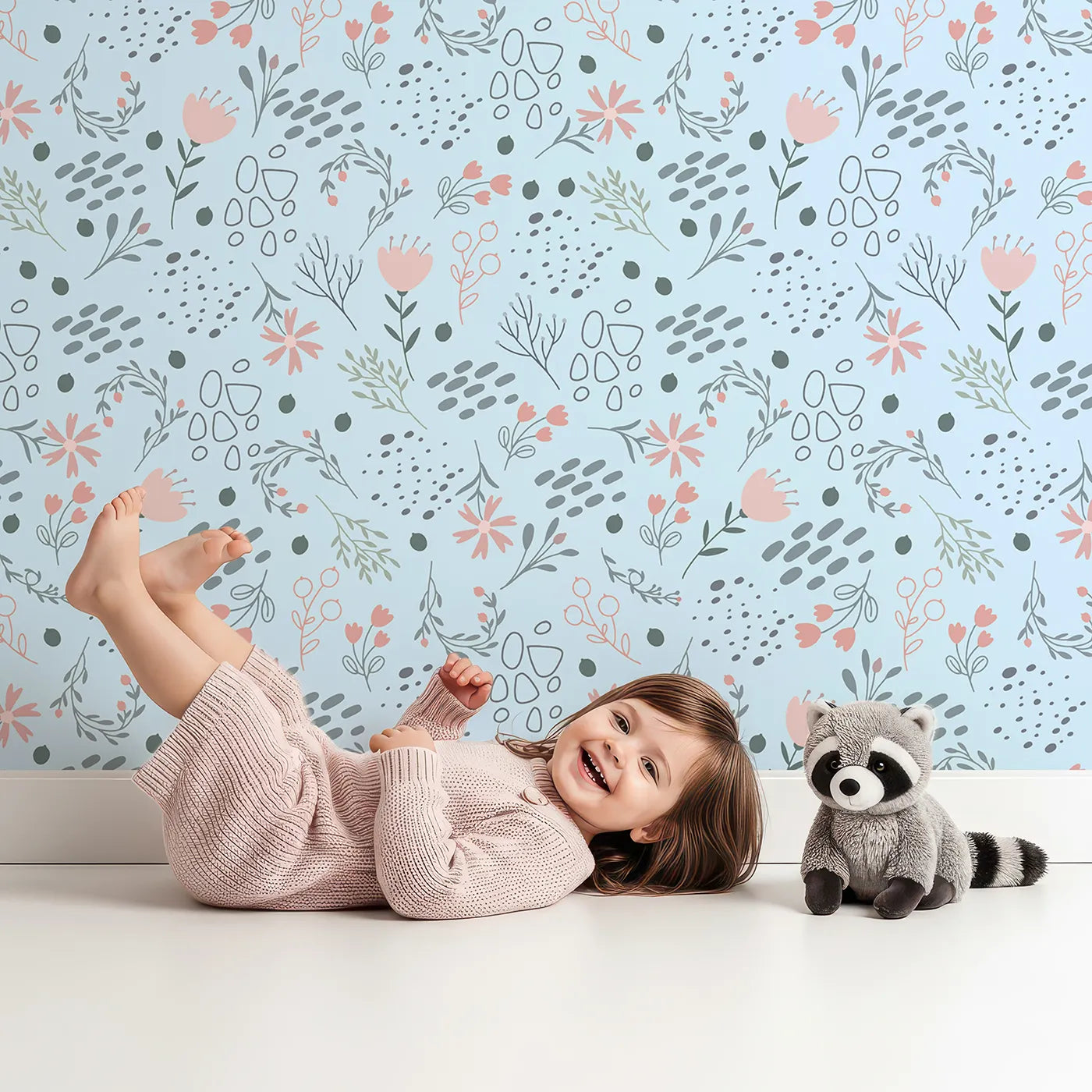 Lovely child standing in front of Whimsy Tots Wildflower Scribble Garden Wallpaper in Sky Sketch with flower, leaf, berry, sketch, doodle in design.
