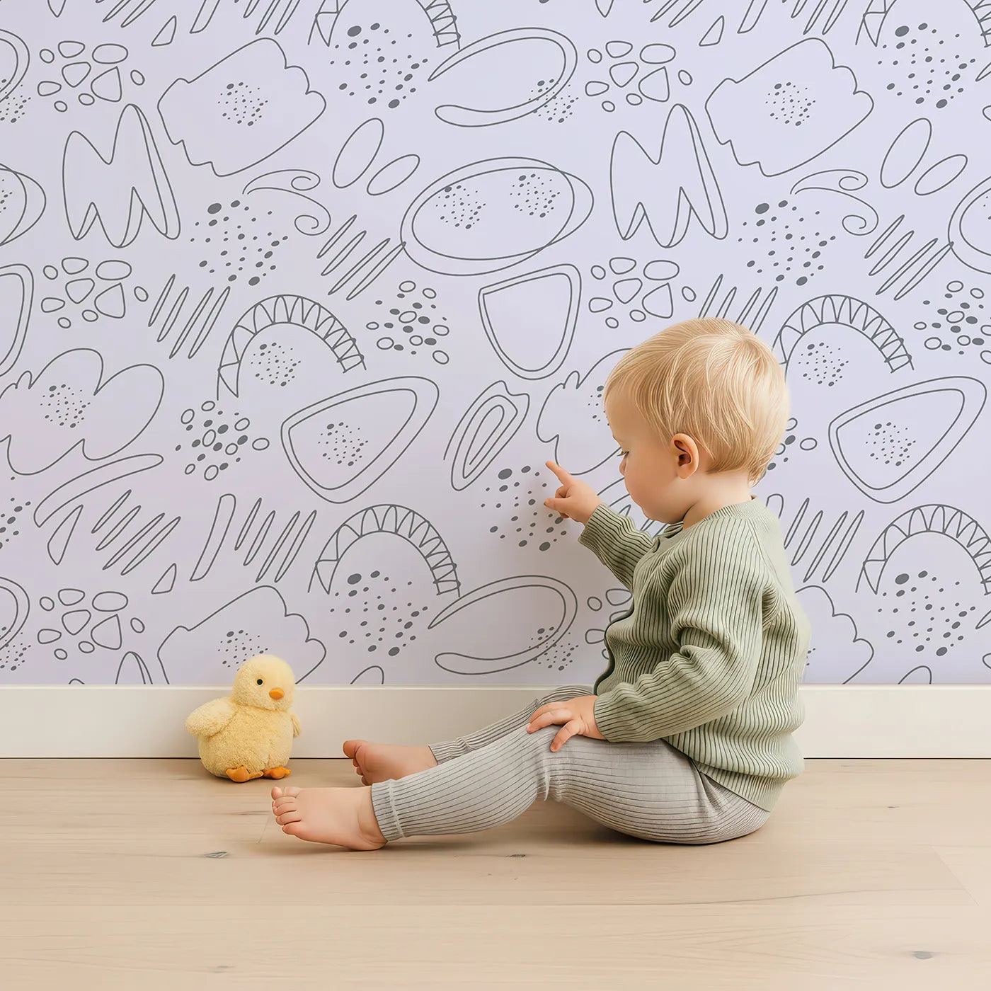 Lovely child standing in front of Whimsy Tots Doodle Meadow Shapes Wallpaper in Lavender with doodle, shape, scribble, petal, arch in design.