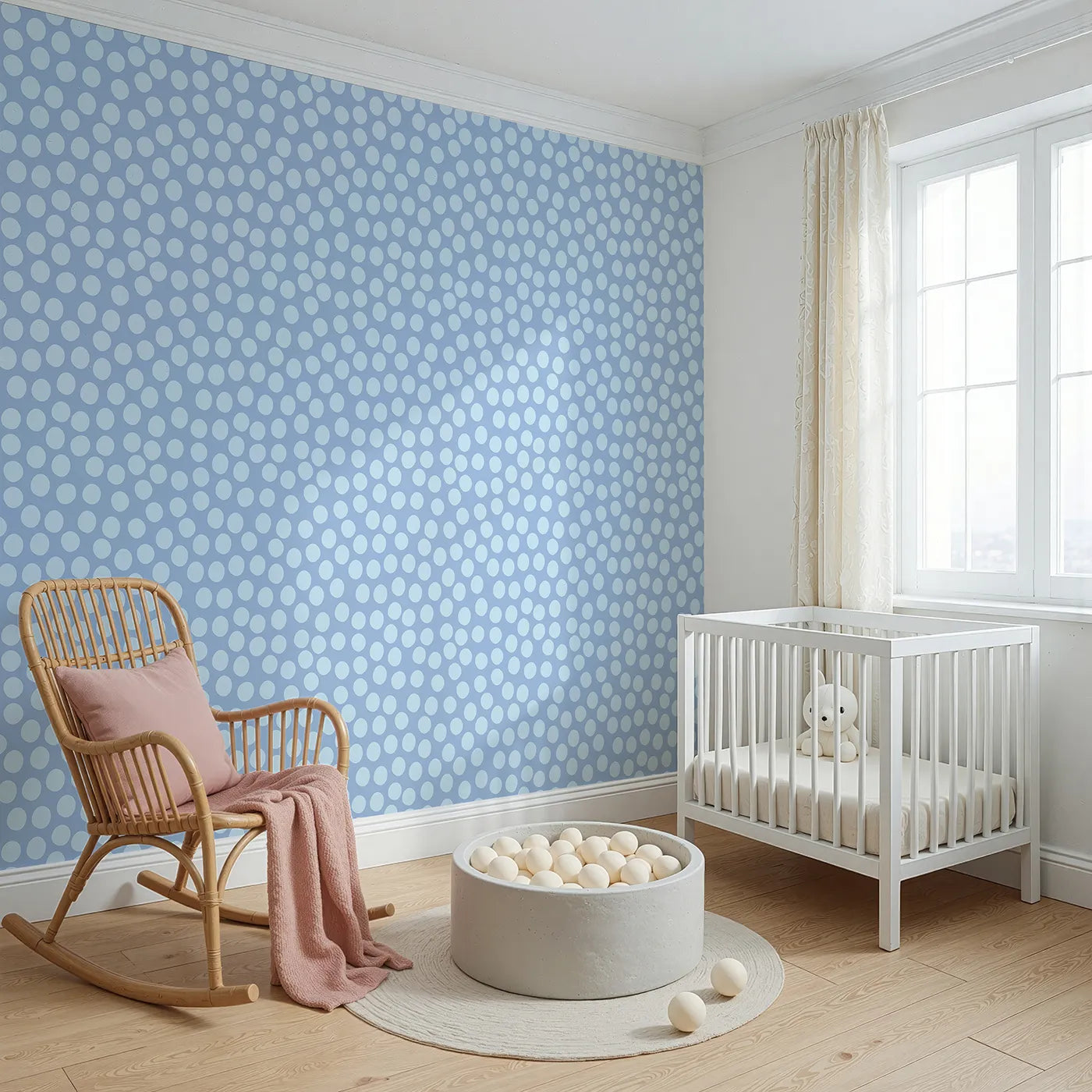 Angled view of Whimsy Tots' Playful Pebble Dots Wallpaper in Periwinkle Blue (W3142D).Dusty blue dots tumble playfully across a periwinkle-toned sky.