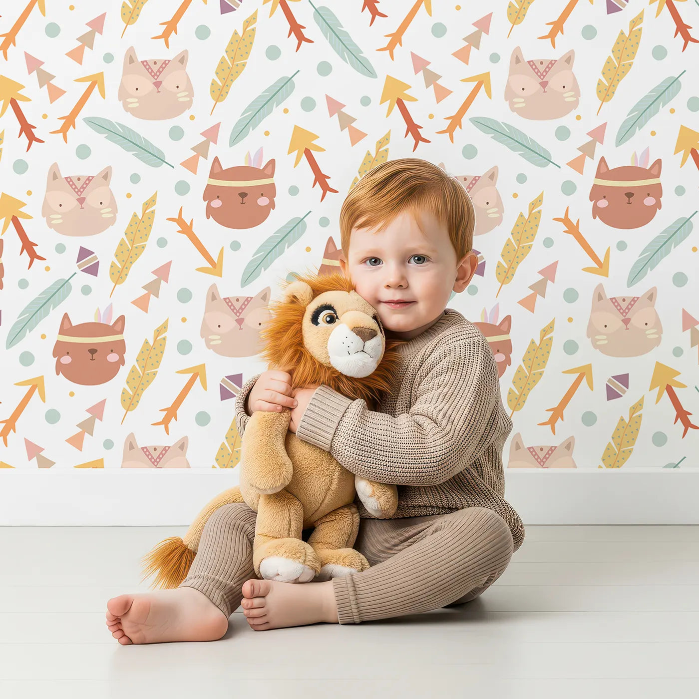 Lovely child standing in front of Whimsy Tots Tribal Kitten Parade Wallpaper in Soft White with cat, feather, arrow, triangle, dot in design.