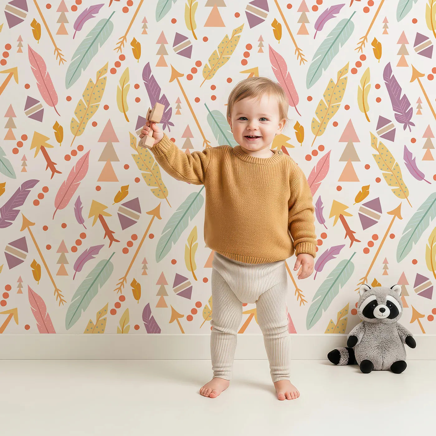 Lovely child standing in front of Whimsy Tots Feather Arrow Confetti Wallpaper in White with arrow, feather, triangle, dot in design.