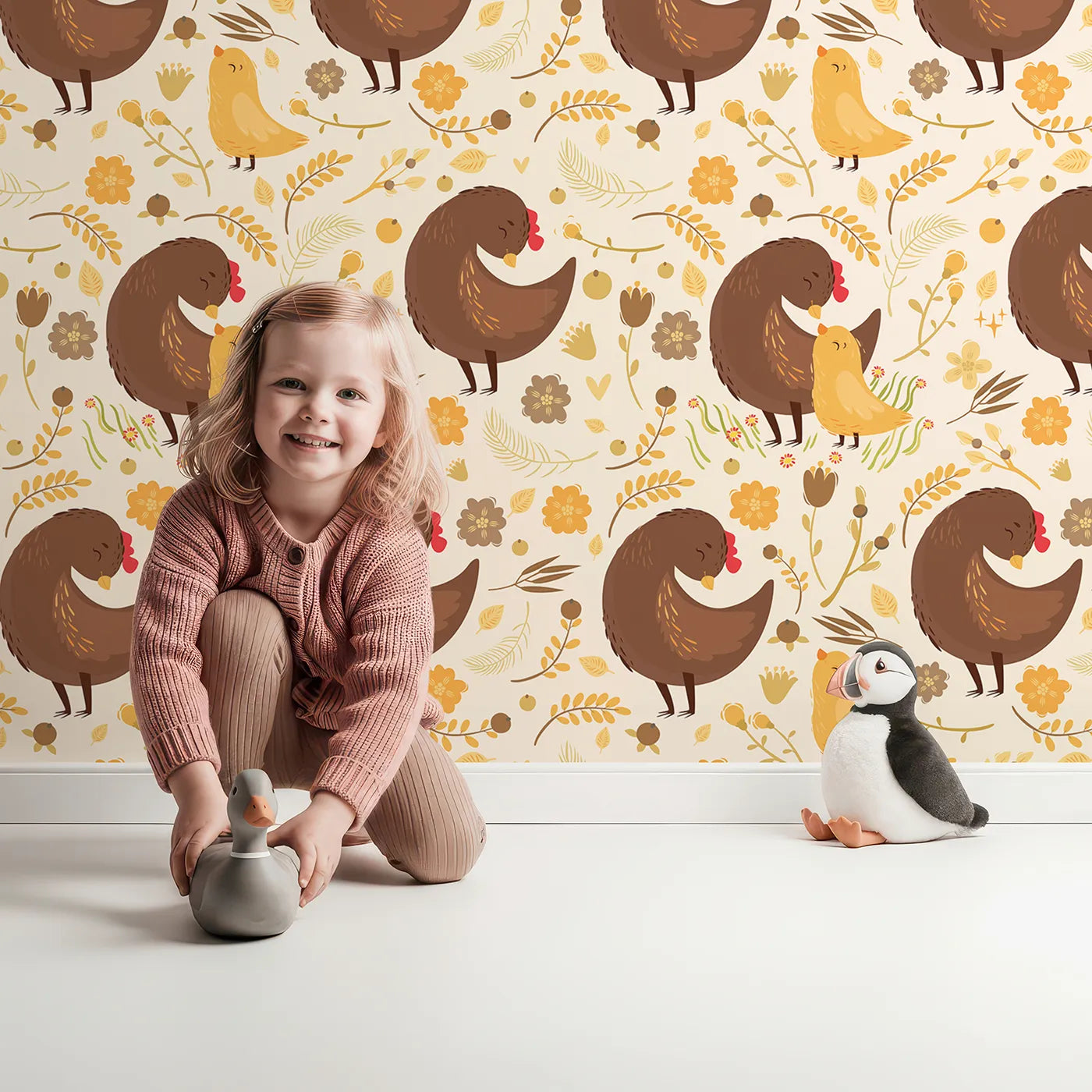 Lovely child standing in front of Whimsy Tots Hen and Chick Meadow Wallpaper in Honey Wheat Yellow with chicken, chick, flower, leaf in design.