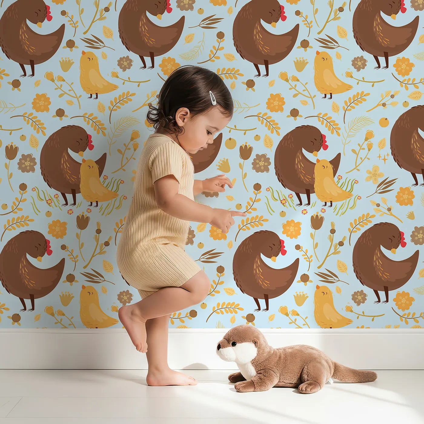 Lovely child standing in front of Whimsy Tots Hen and Chick Meadow Wallpaper in Sky Blue with chicken, chick, flower, leaf in design.