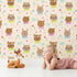 Lovely child standing in front of Whimsy Tots Heart Bloom Critters Wallpaper in Cream with bear, rabbit, owl, heart, flower, cloud in design. Lovely child standing in front of Whimsy Tots Heart Bloom Critters Wallpaper in Cream with bear, rabbit, owl, heart, flower, cloud in design.