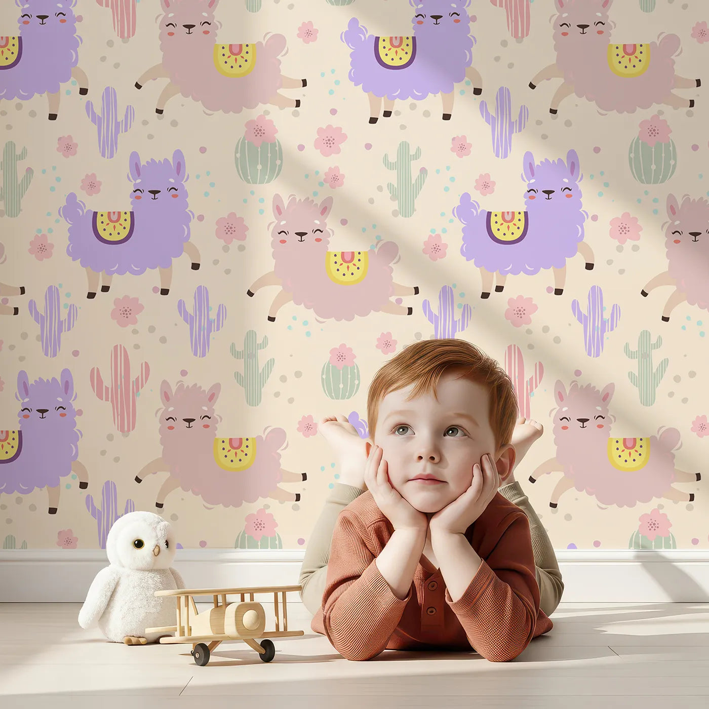 Lovely child standing in front of Whimsy Tots Bouncing Llama Fiesta Wallpaper in Cream with llama, cactus, flower, confetti in design.