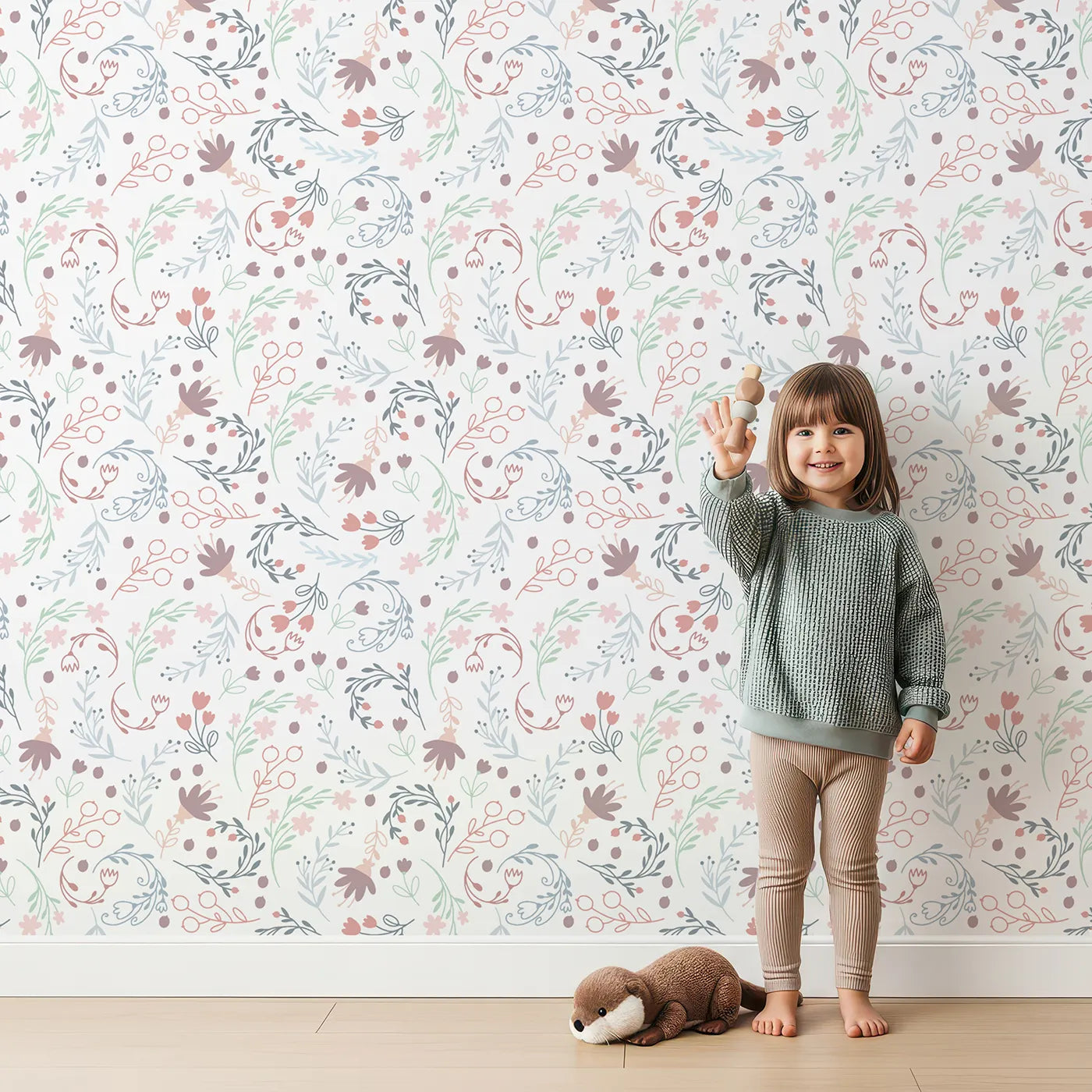 Lovely child standing in front of Whimsy Tots Fairy Petal Garden Wallpaper in White with fairy, flower, leaf, berry in design.
