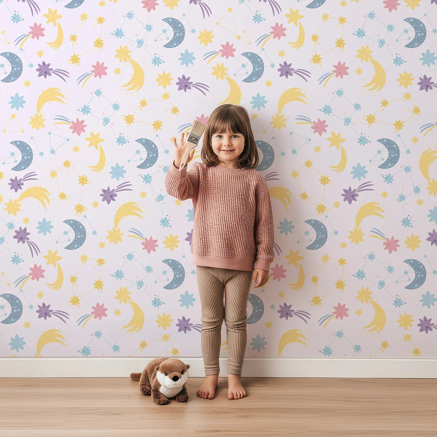 Lovely child standing in front of Whimsy Tots Starlit Wishes Wallpaper in Lavender with moon, star, constellation, shooting star, galaxy in design.