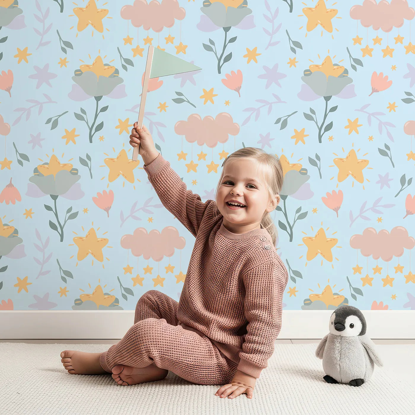 Lovely child standing in front of Whimsy Tots Starlight Blossom Dreams Wallpaper in Morning Sky with star, flower, cloud, leaf in design.